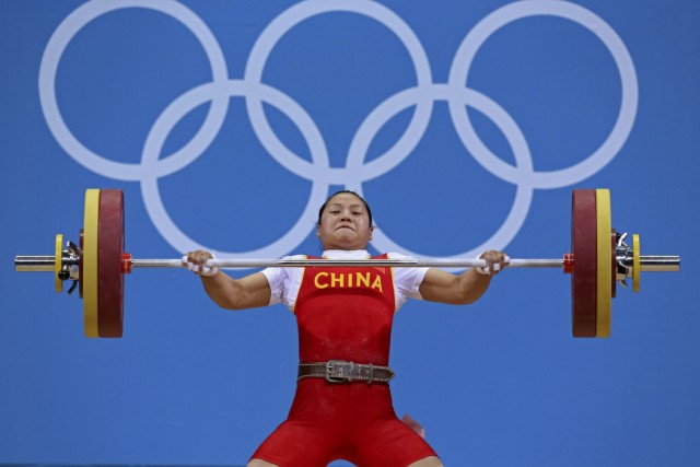China's Xueying Li lifts 108 Kg on snatch setting new Olympic record on the women's 58Kg Group A weightlifting competition at the London 2012 Olympic Games