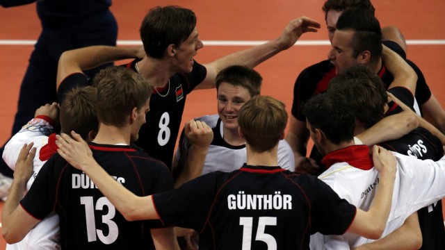 Germany's players celebrate after defeating Serbia during their men's Group B volleyball match at Earls Court during the London 2012 Olympic Games