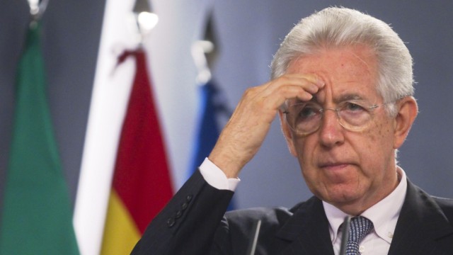 Italy's PM Monti gestures during a news conference at the Moncloa Palace in Madrid