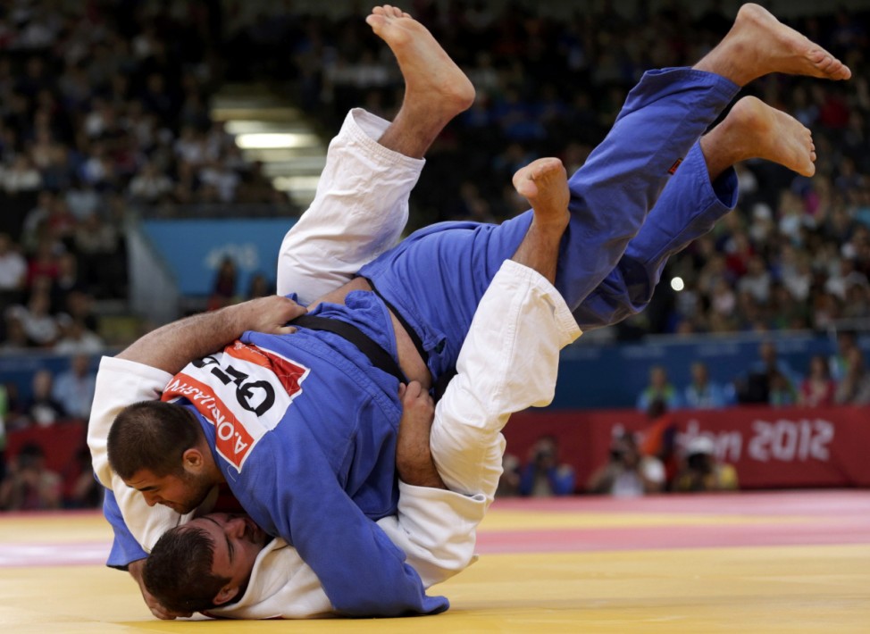 Germany's Andreas Toelzer fights with Georgia's Adam Okruashvili during their men's +100kg elimination round of 32 judo match at the London 2012 Olympic Games
