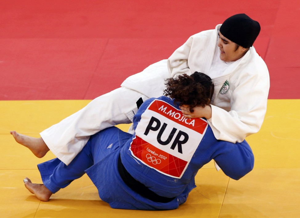 Saudi Arabia's Wojdan Shaherkani fights with Puerto Rico's Melissa Mojica during their women's +78kg elimination round of 32 judo matchat the London 2012 Olympic Games