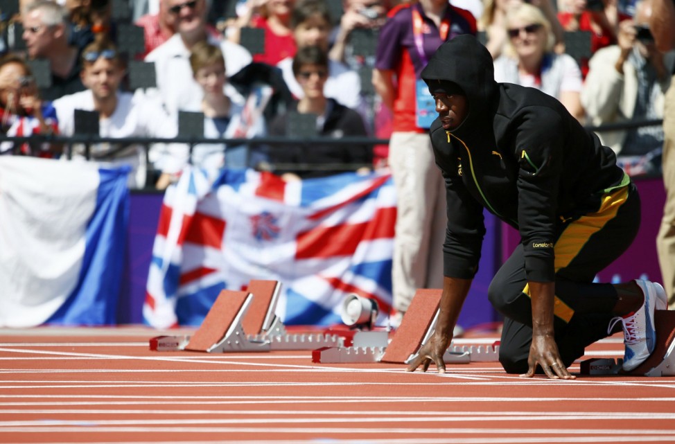Jamaica's Usain Bolt prepares before competing in his men's 100m round 1 heat at the London 2012 Olympic Games at the Olympic Stadium