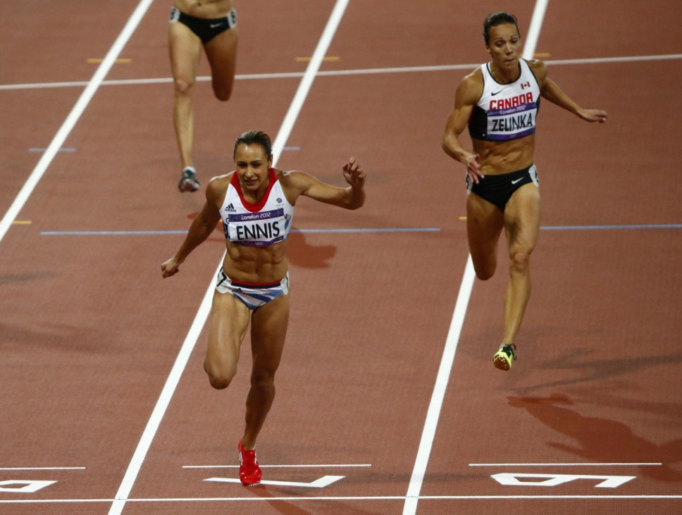 Britain's Jessica Ennis (L) finishes ahead of Canada's Zelinka react in heat 5 of the women's heptathlon 200m at the London 2012 Olympic Games at the Olympic Stadium
