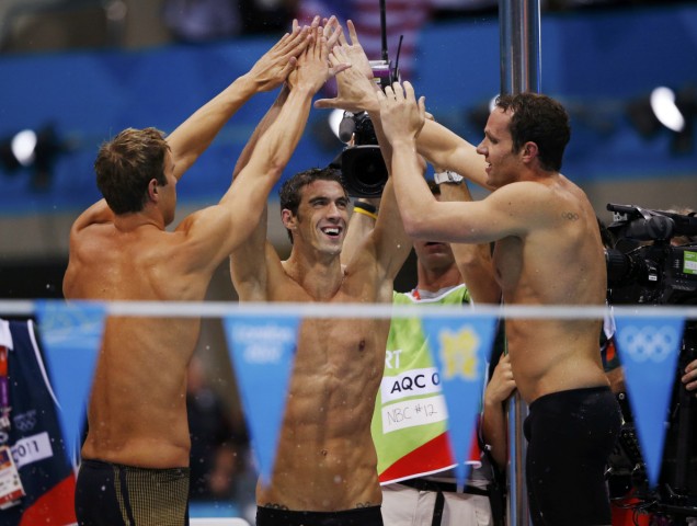 Michael Phelps, Matthew Grevers (L) and Brendan Hansen (R) of the U.S. celebrate after team mate Nathan Adrian swam to win the gold in the men's 4x100m medley relay final during the London 2012 Olympic Games at the Aquatics Centre