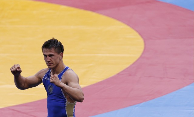 Russia's Roman Vlasov celebrates victory over Lithuania's Aleksandr Kazakevic on the Men's semifinals 74Kg Greco-Roman wrestling at the ExCel venue during the London 2012 Olympic Games