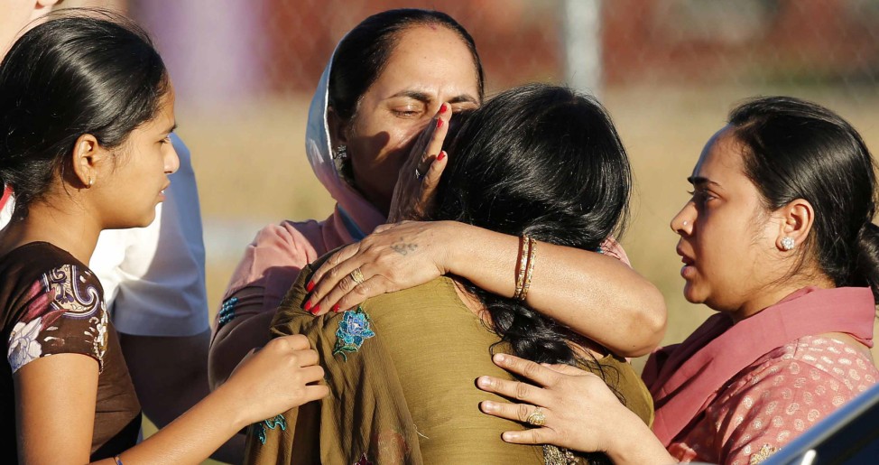 A distraught women is comforted outside of the Sikh temple in Oak Creek, Wisconsin