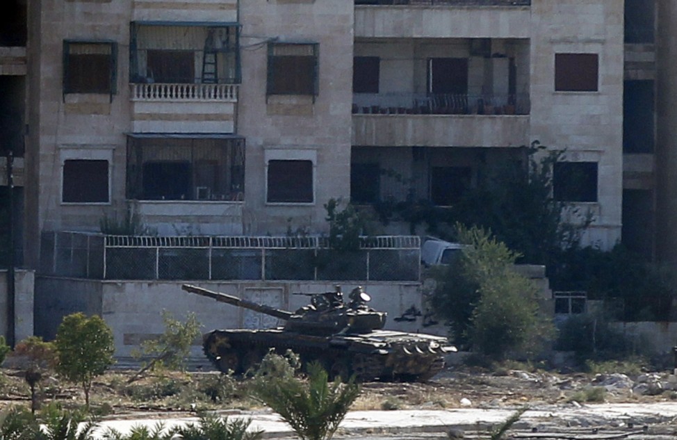 A Syrian Army tank is seen from Salah al-Din neighbourhood in central Aleppo
