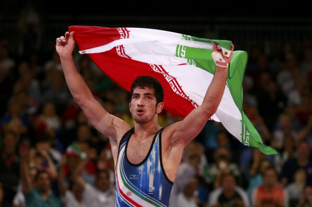 Iran's Omid Haji Noroozi celebrates his victory on the on the Men's 60Kg Greco-Roman wrestling at the ExCel venue during the London 2012 Olympic Games