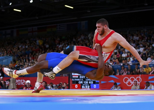 Cuba's Mijain Lopez Nunez fights with Egypt's Abdelrahman Eltrabily on the Men's 120Kg Greco-Roman wrestling at the ExCel venue during the London 2012 Olympic Games