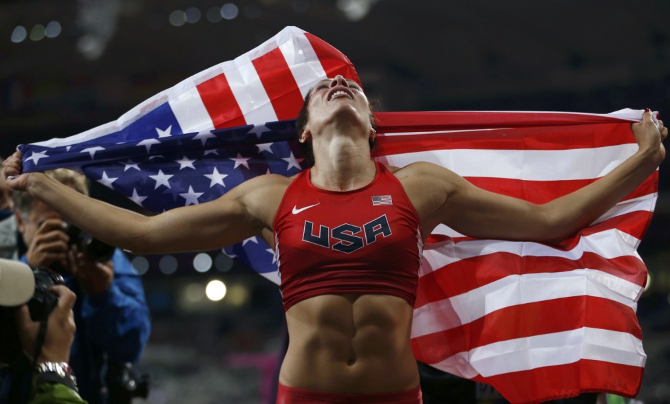 Jennifer Suhr of the U.S. holds her national flag after winning the women's pole vault final at the London 2012 Olympic Games