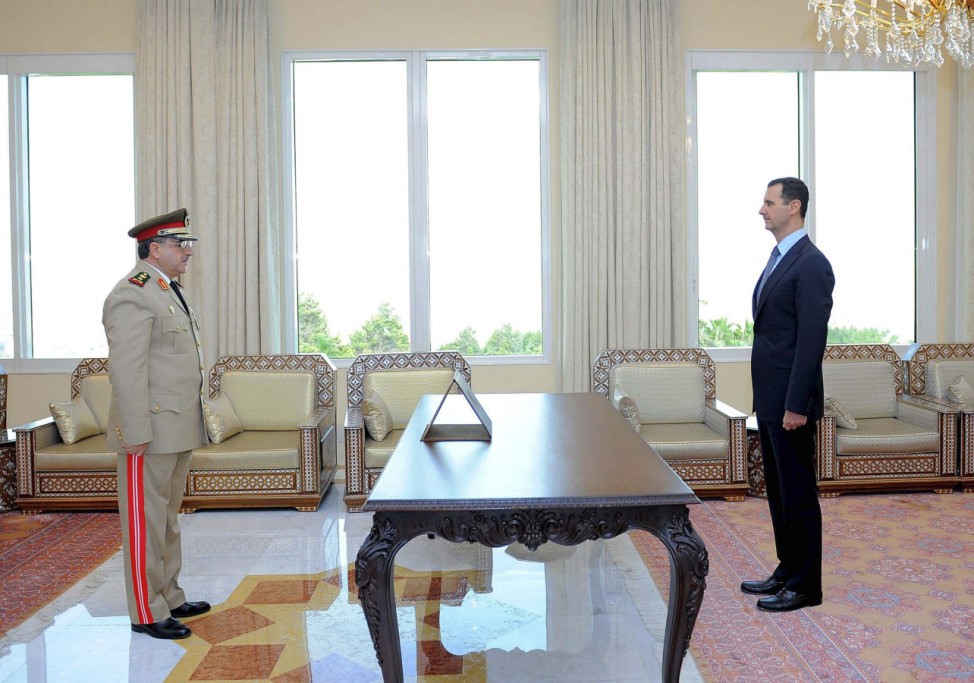 File photo of Daoud Rajha being sworn in as Deputy PM and Defense Minister by Syrian President Assad in Damascus