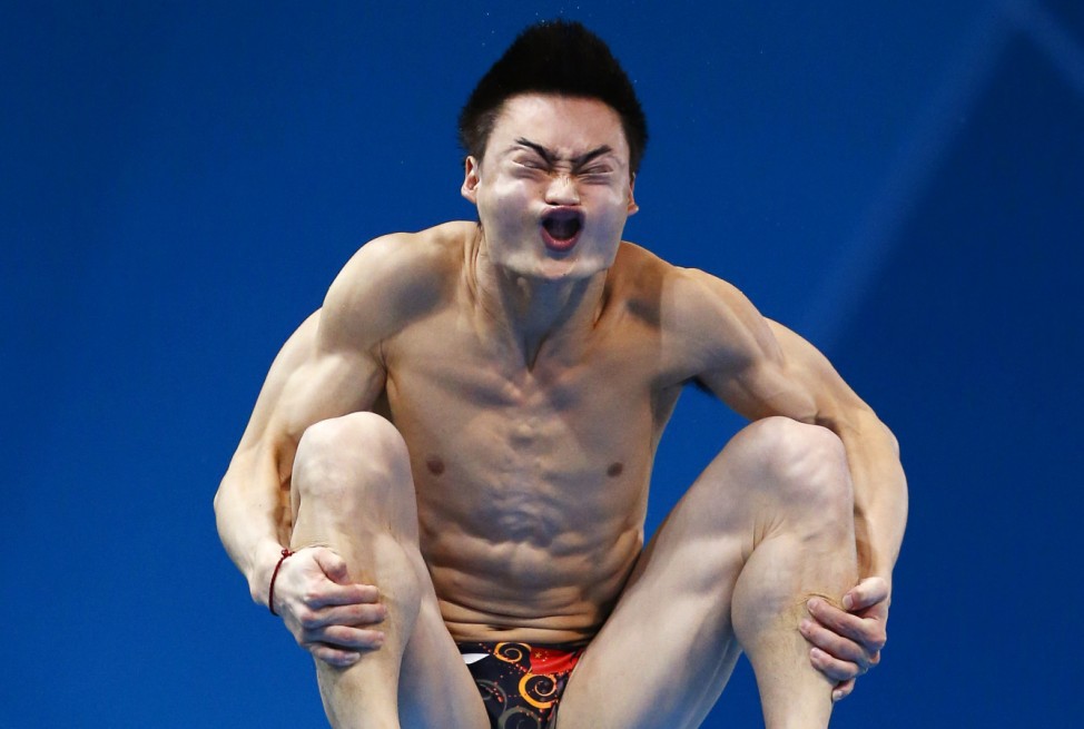 China's Qin Kai performs a dive during the men's 3m springboard preliminary round at the London 2012 Olympic Games at the Aquatics Centre