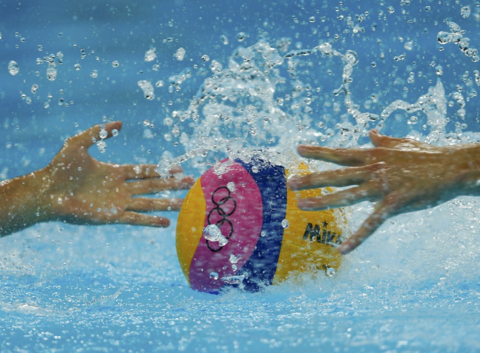 Britain's and Montenegro's athletes compete for possession during their preliminary round Group B water polo match at the Water Polo Arena during the London 2012 Olympic Games