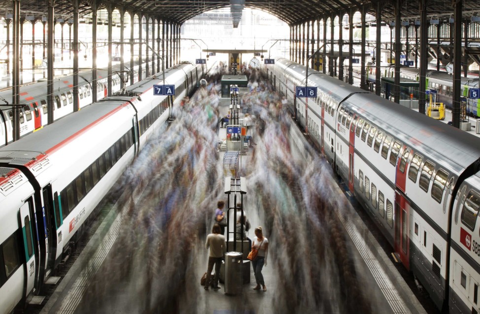A long exposure picture shows commuters walking on a platform after leaving a train of the Swiss Federal Railways (SBB) at the main station in Lucerne