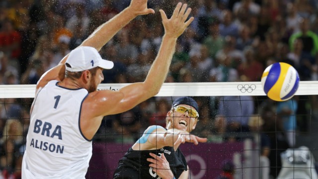 Germany's Jonas Reckermann spikes against Brazil's Alison during their men's beach volleyball gold medal match at the London 2012 Olympic Games