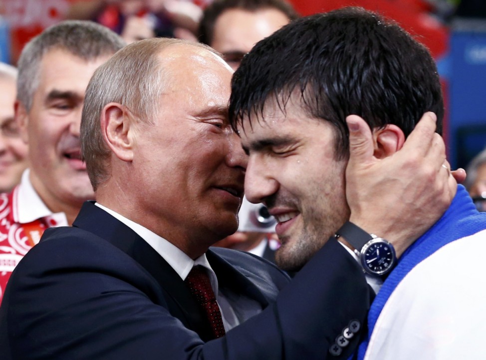 Russian President Vladimir Putin congratulates Russia's Tagir Khaibulaev after winning men's -100kg final judo match at London 2012 Olympic Games