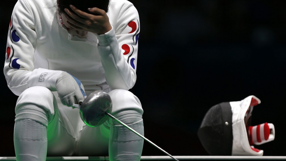 South Korea's Shin reacts after being defeated by Germany's Heidemann during their women's epee individual semifinal fencing competition at the ExCel venue at the London 2012 Olympic Game