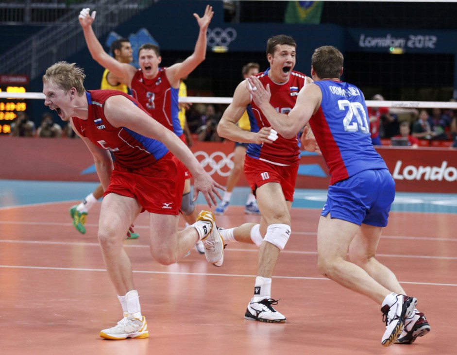 Russia players celebrate victory against Brazil in their men's gold medal volleyball match against Brazil at the London 2012 Olympic Games