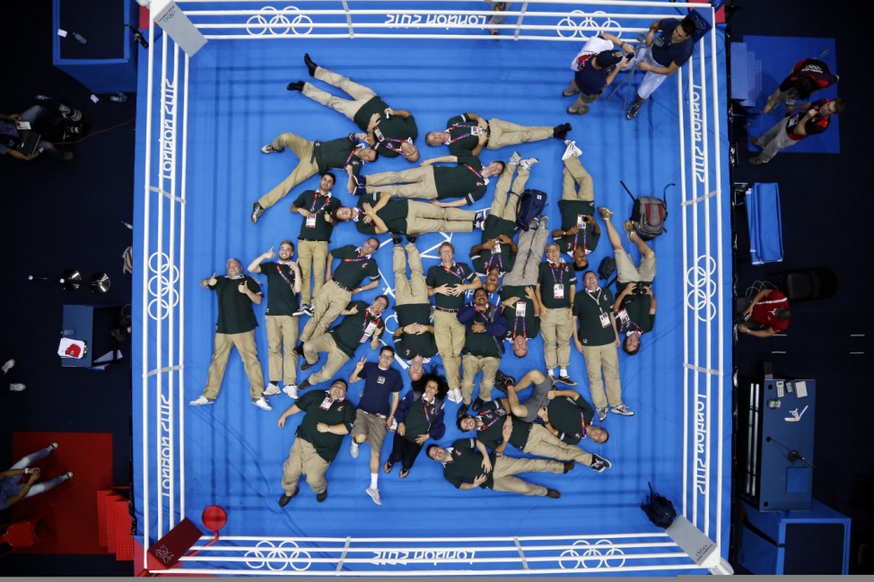 Technicians pose for a souvenir photo at the conclusion of the boxing competition at the London Olympic Games