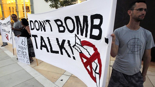 Israeli protesters hold a banner to call on Israel not to bomb Iran during a demonstration calling for social justice in Tel Aviv
