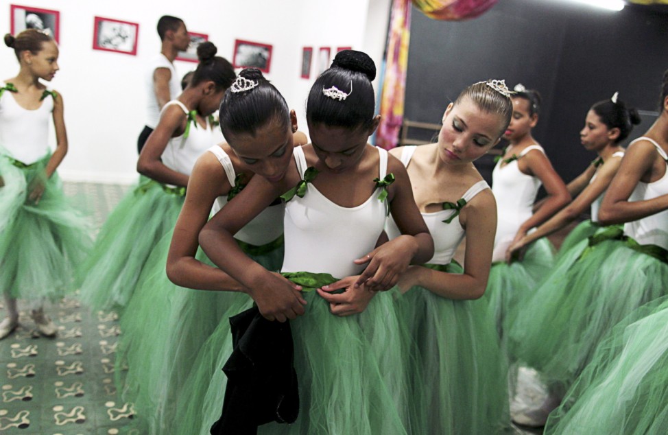 Girls fit their ballet skirts during their ballet class at the 'Ballet Santa Teresa' academy in Rio de Janeiro