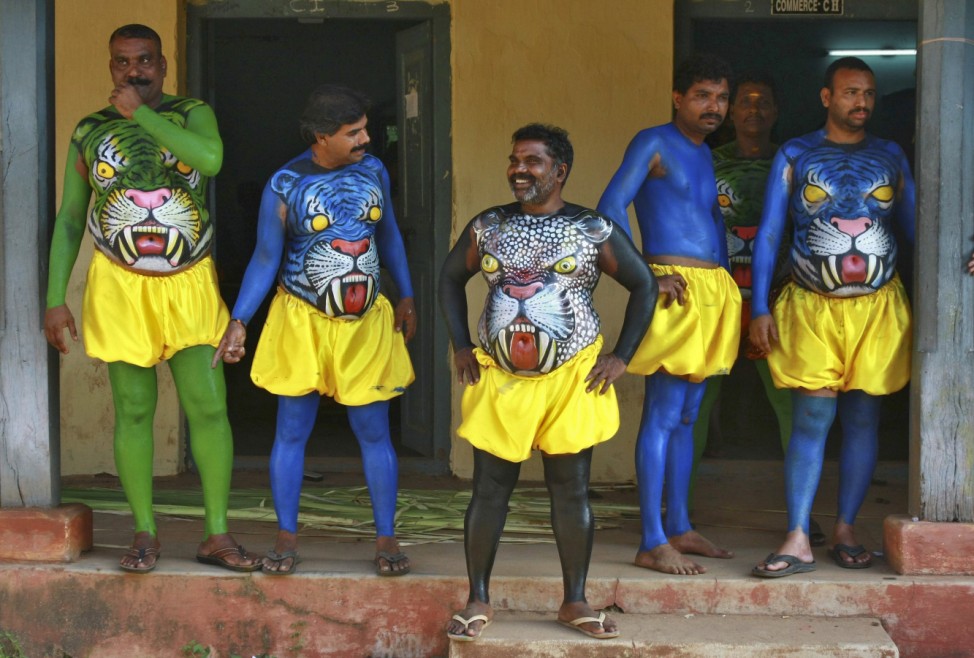 Dancers in body paint wait to take part in a performance during festivities marking the start of the annual harvest festival of 'Onam' in the southern Indian city of Kochi