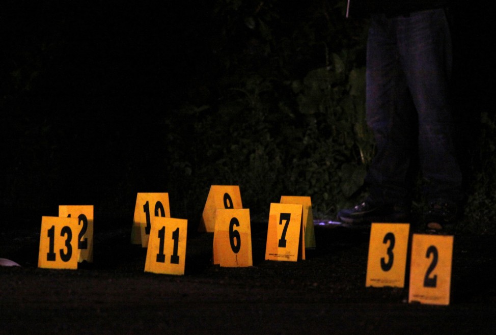Evidence markers stand on a street at a crime scene where a man had been shot dead in Cuernavaca