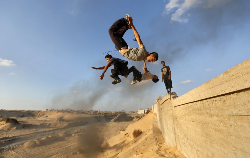 Palestinian youths practice their parkour skills in Khan Younis in the southern Gaza Strip