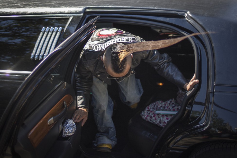 Japanese fashion designer Kazuhiro Watanabe, who holds the world record for the 'Tallest Mohawk,' carefully enters a limousine after a media event in New York