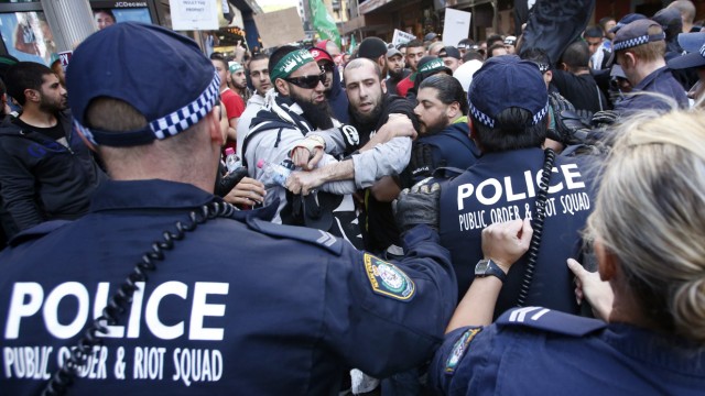 Protesters clash with police on a street in Sydney's central business district