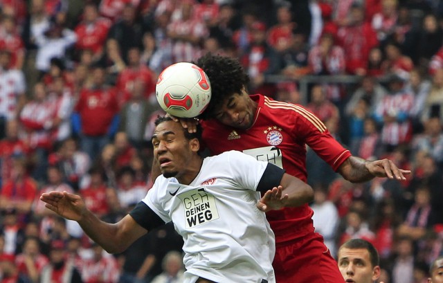 Bayern Munich's Dante heads ball with Choupo-Moting of Mainz 05 during German Bundesliga soccer match in Munich