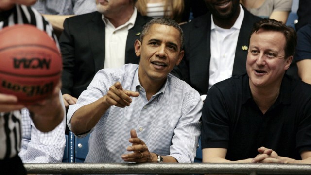 U.S. President Obama and British Prime Minister Cameron talk at NCAA basketball tournament game in Ohio