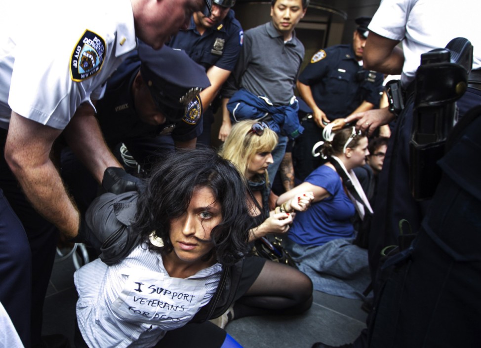 New York Police Department officers arrest a Occupy Wall Street activist outside of the headquarters of Goldman Sachs during demonstrations through the financial district on the one-year anniversary of the movement in New York