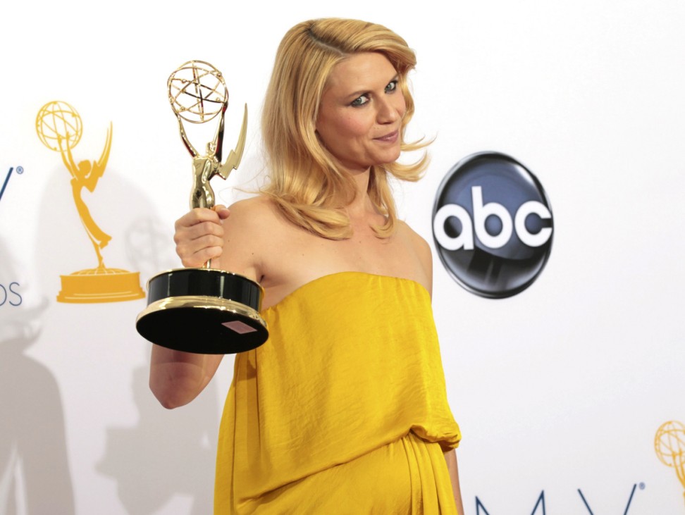 Claire Danes raises the Emmy award for outstanding lead actress in a drama series for her role in 'Homeland' at the 64th Primetime Emmy Awards in Los Angeles