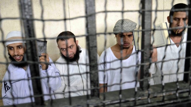 Militant Islamists react as they attend their verdict at a court in Ismailia city