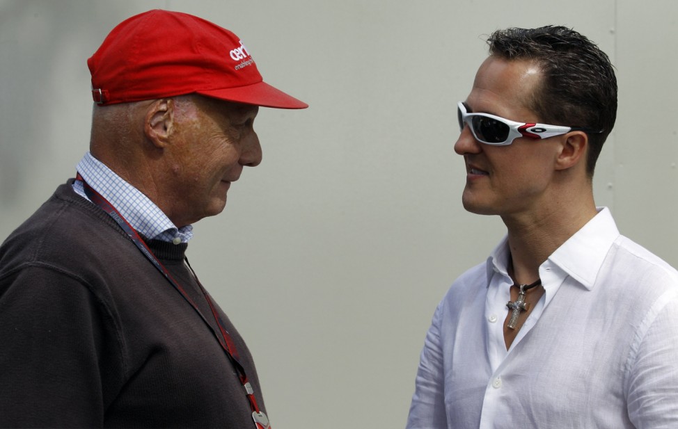 Mercedes Formula One driver Michael Schumacher speaks with former F1 world champion Niki Lauda at Albert Park race track for the Australian F1 Grand Prix in Melbourne