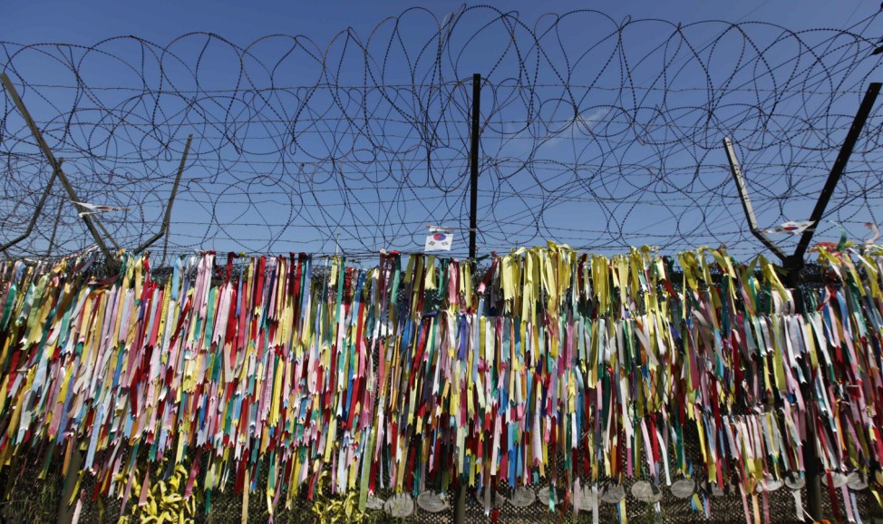 Ribbons bearing messages wishing for unification of two Koreas hang on barbed-wire fence at Imjingak pavilion