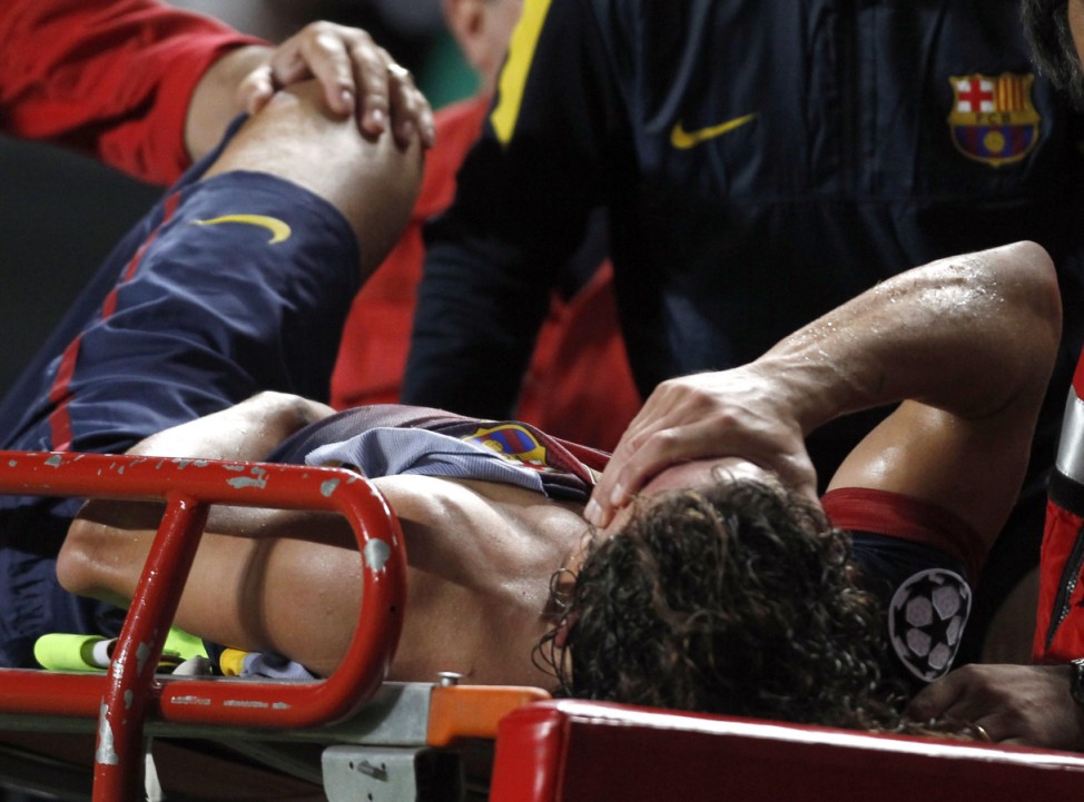 Barcelona's Carles Puyol is taken off the pitch on a stretcher after sustaining an injury against Benfica during their Champions League Group G soccer match at the Luz stadium in Lisbon