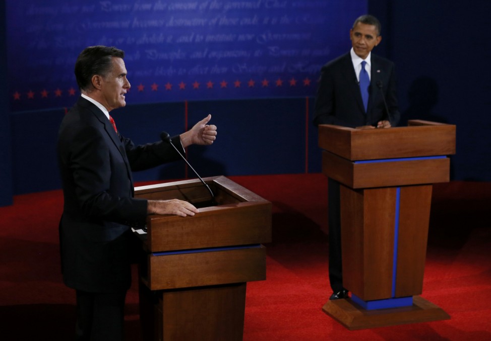 Republican presidential nominee Mitt Romney answers a question as President Barack Obama listens during the first 2012 U.S. presidential debate in Denver