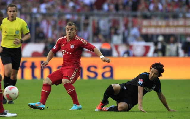 Bayern Munich's Shaqiri fights for ball with Hoffenheim's Usami during Bundesliga soccer match in Munich