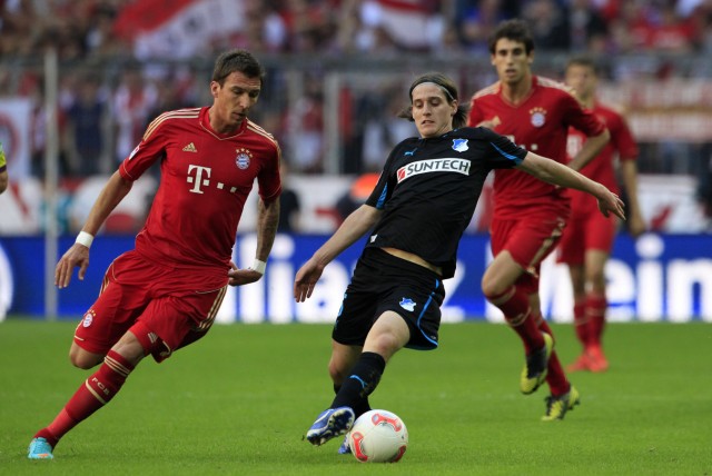 Bayern Munich's Mandzukic fights for ball with Hoffenheim's Rudy during Bundesliga soccer match in Munich