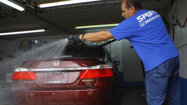 Auto detailer Rick Overby washes and preps a new 2013 Honda Accord at Sport Honda in Silver Spring Maryland