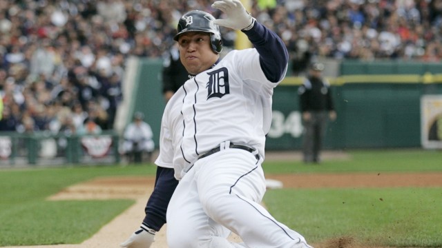 Detroit Tigers Cabrera slides into home plate to score a run during the third inning of Game 2 in Detroit