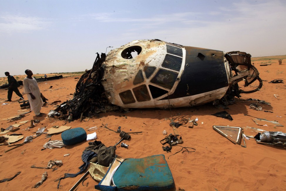 People look at the remains of a Sudanese military plane after it crashed at the North Korodofan State border near Khartoum