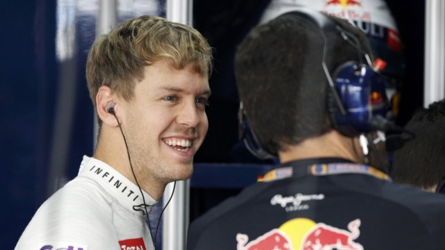 Red Bull Formula One driver Vettel talks to a crew member during the third practice session of the South Korean F1 Grand Prix at the Korea International Circuit in Yeongam