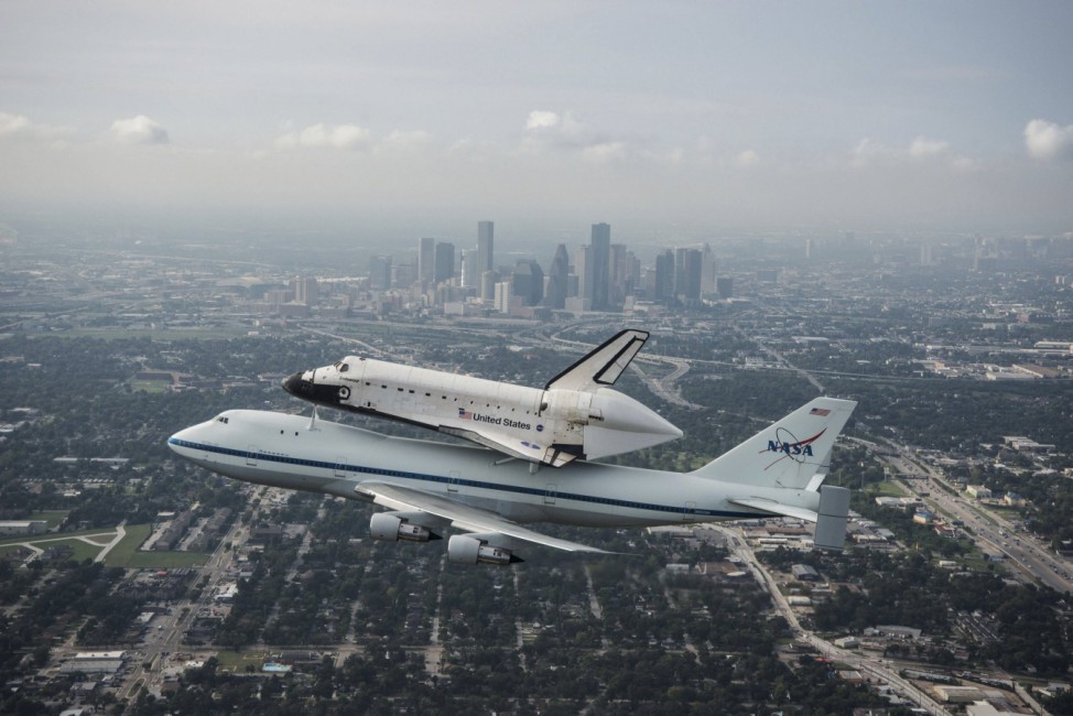 Handout of the space shuttle Endeavour, atop NASA's Shuttle Carrier Aircraft at it flies over Houston