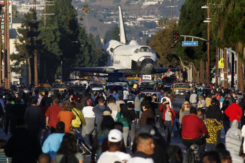 Crowds gather to view the Space Shuttle Endeavour as its transported on Martin Luther King Jr Boulevard in Los Angeles, California