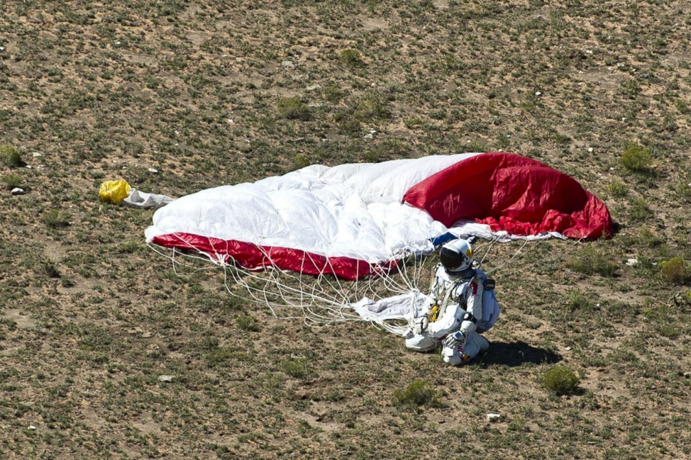 Handout photo of pilot Felix Baumgartner of Austria celebrating after successfully completing the final manned flight for Red Bull Stratos in Roswell