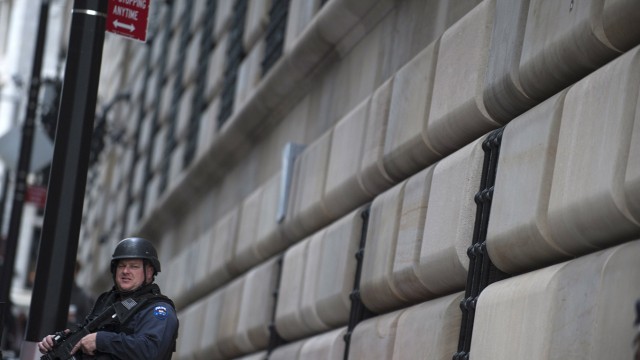 A New York City Police officer stands guard in front of the New York Federal Building in New York