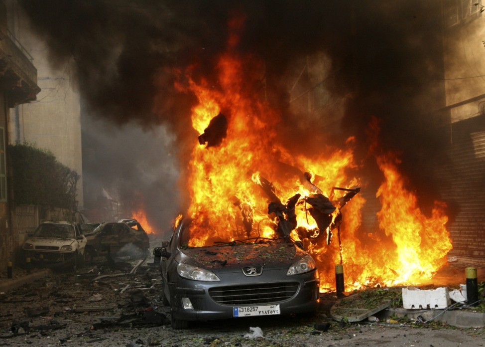 A car burns at the site of an explosion in Ashrafieh